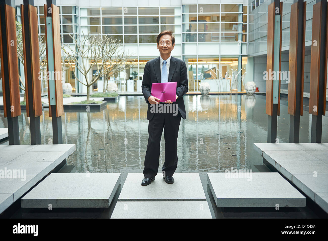 Jonney Shih, Chairman of ASUS, holding an ASUS ZENBOOK inside the Zen  Garden of the ASUSTek Headquarters in Taiwan Stock Photo - Alamy
