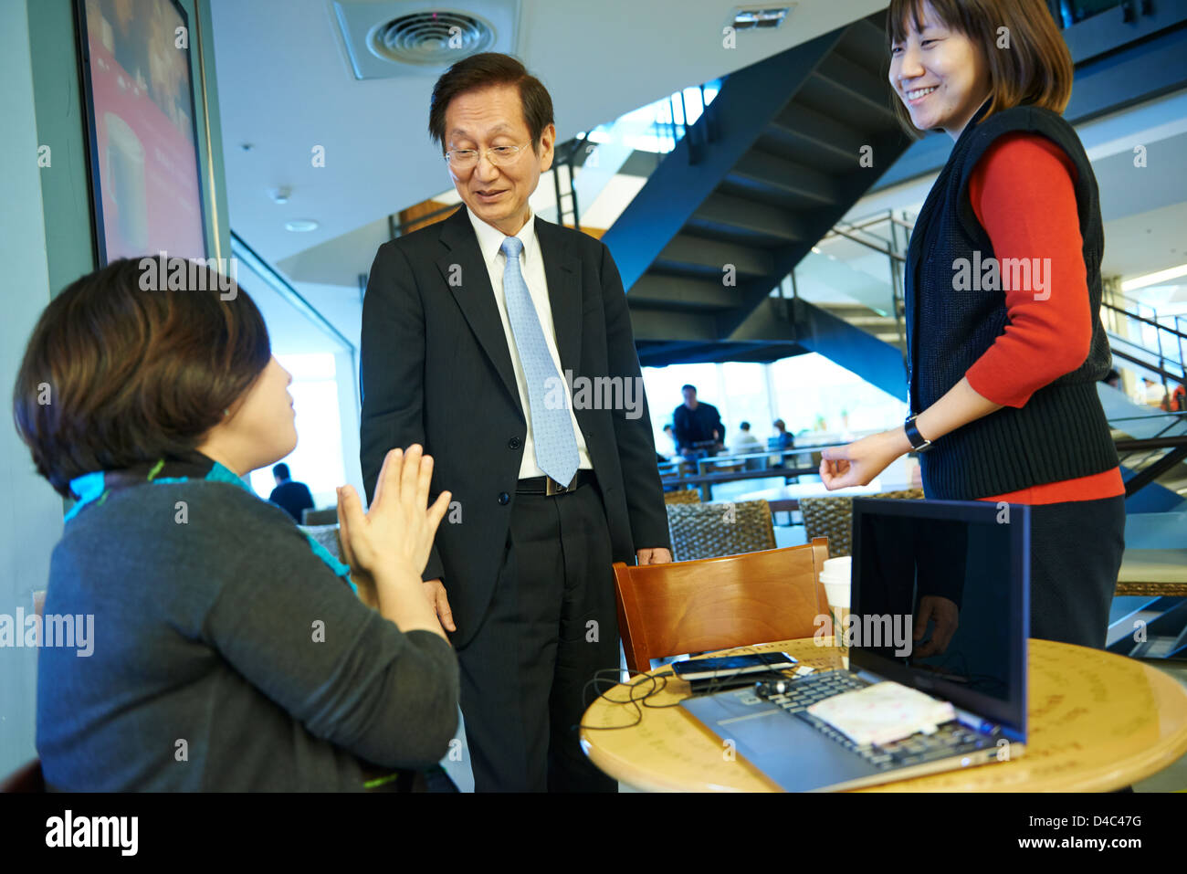 Jonney Shih, Chairman of ASUS, interacts with coworkers at Starbucks on campus of the ASUS Headquarters in Taiwan. Stock Photo