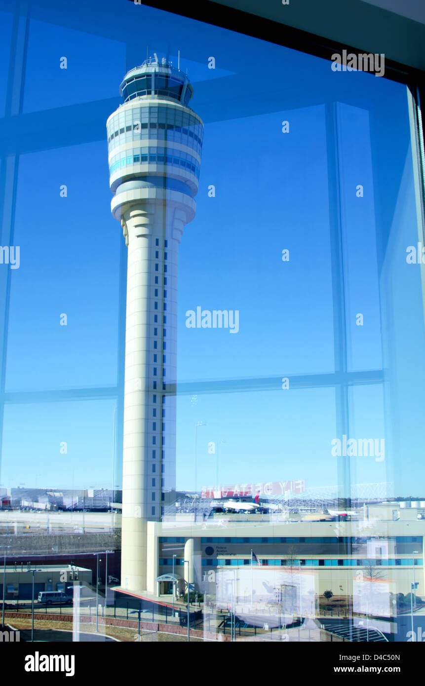 Looking out the terminal window at the air traffic control tower at the Atlanta Airport. Stock Photo