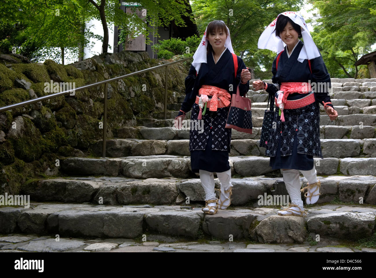 Two 'oharame' (Ohara girls) in traditional costume walking around the rural countryside village of Ohara, Kyoto, Japan. Stock Photo