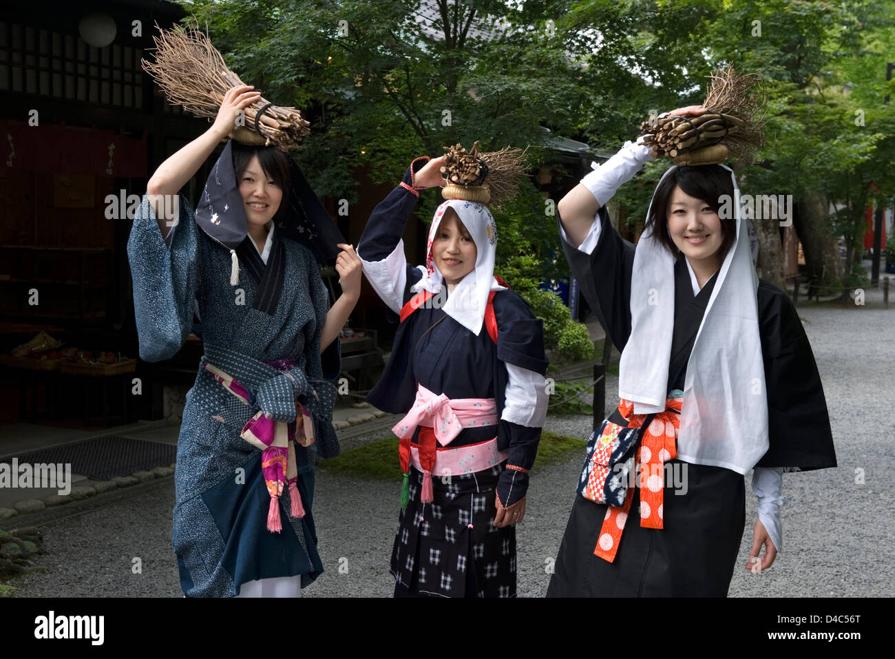 'Oharame' (Ohara girls) in traditional costume carrying fire wood in the rural village of Ohara, Kyoto, Japan. Stock Photo