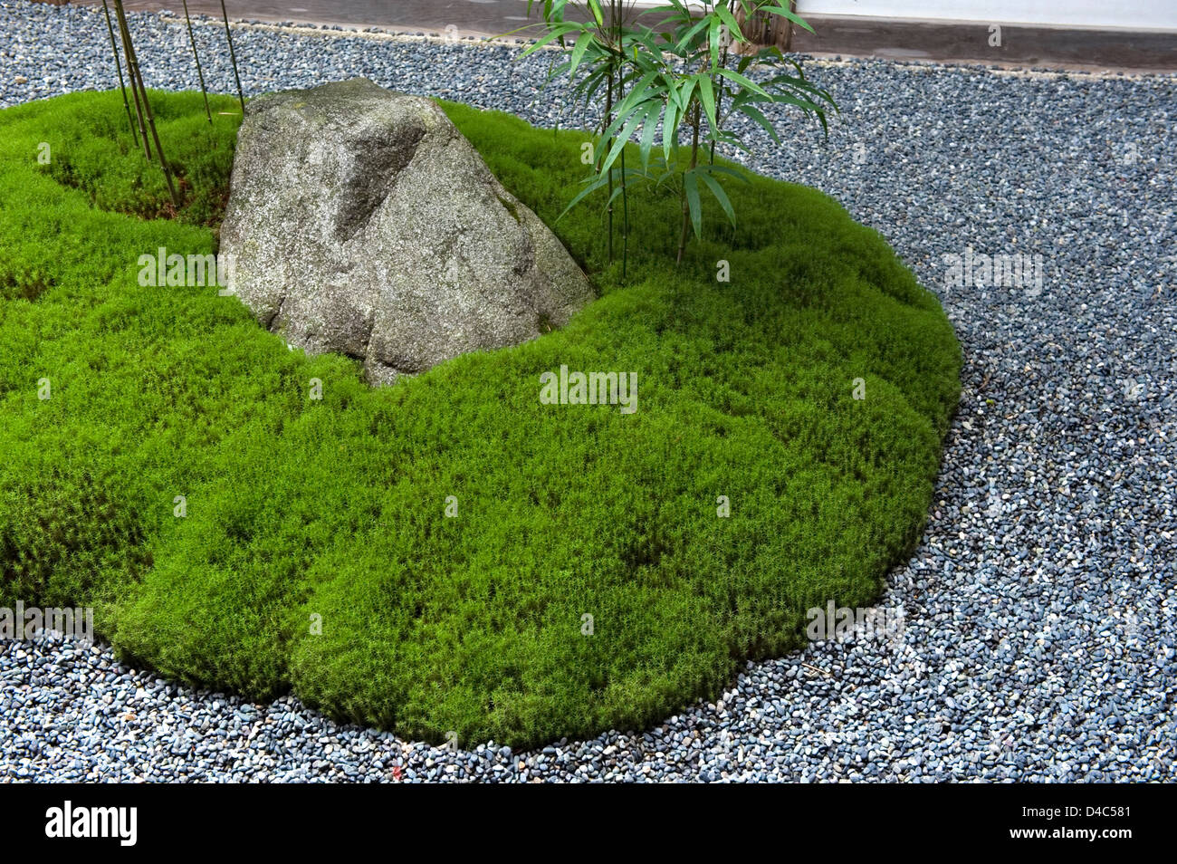 A carefully manicured moss island highlights a landscape rock garden at Sanzenin Temple in Ohara, Kyoto, Japan. Stock Photo
