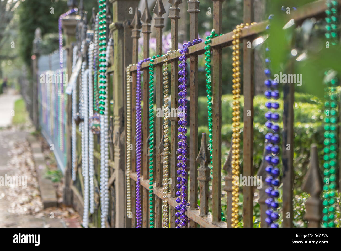 mardi gras beads on fence