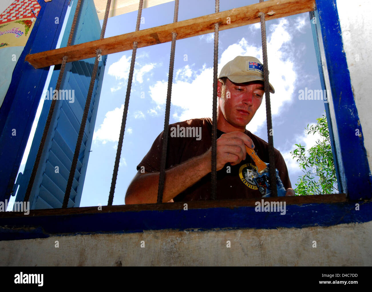 U S Army Combat Engineer Lance Cpl Sam Marshall Dips His Paint Brush 
