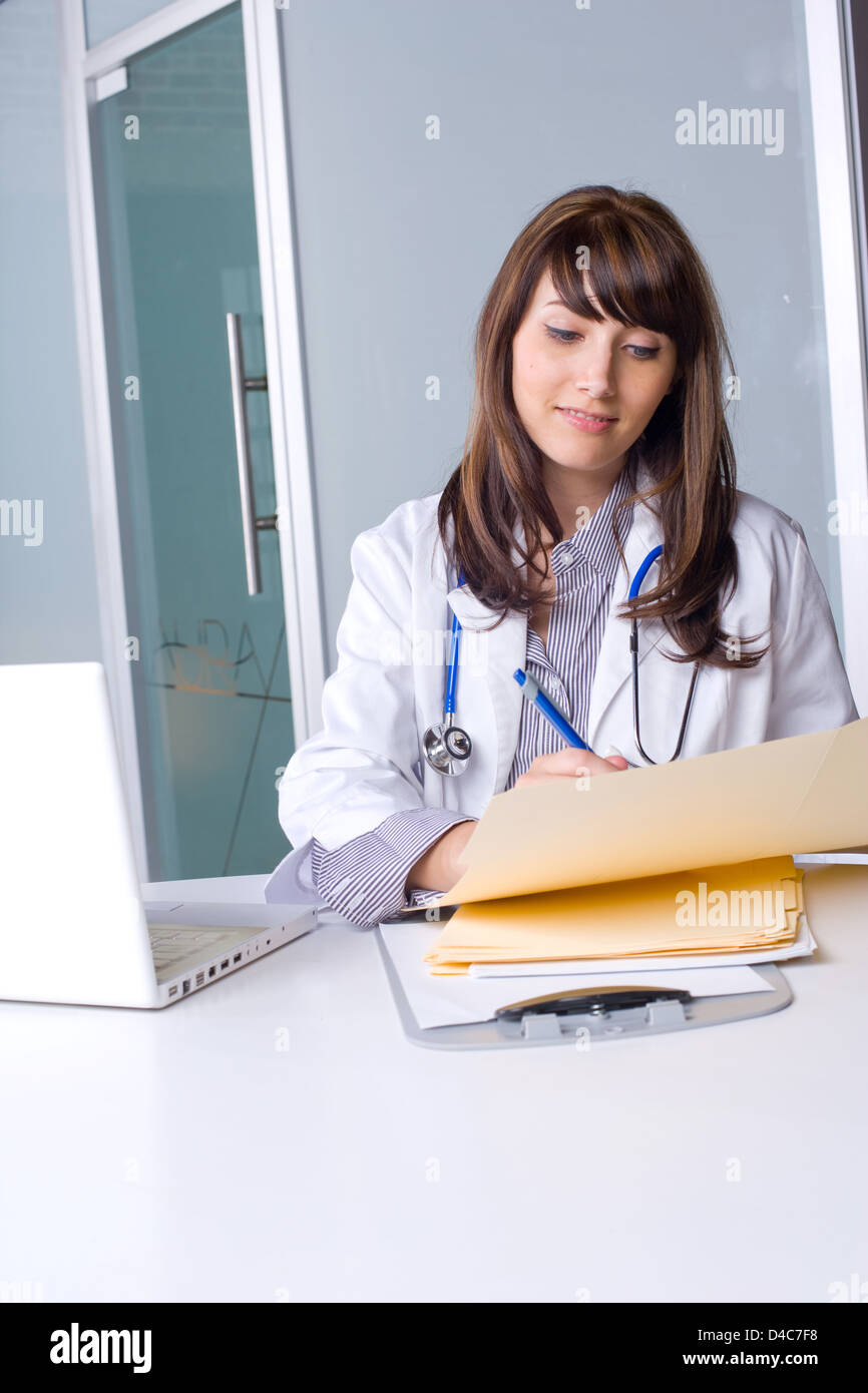 Woman doctor holding a chart in a modern office Stock Photo