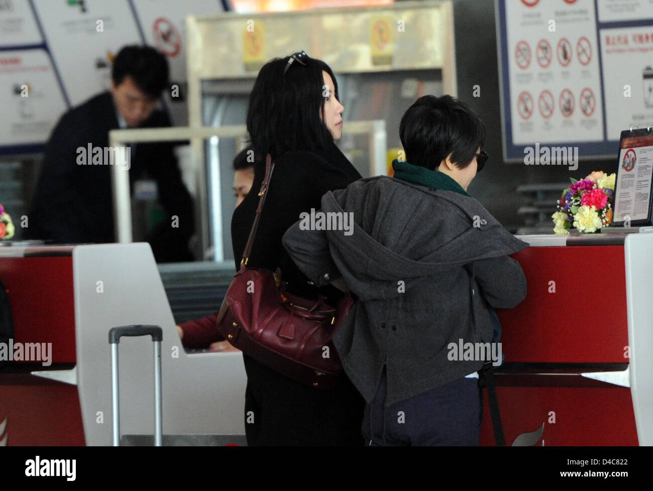 Faye Wong at the airport with her assistants in Beijing, China on Monday March 11, 2013. Stock Photo