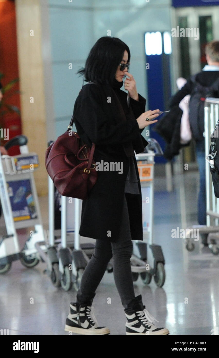 Faye Wong at the airport with her assistants in Beijing, China on Monday March 11, 2013. Stock Photo