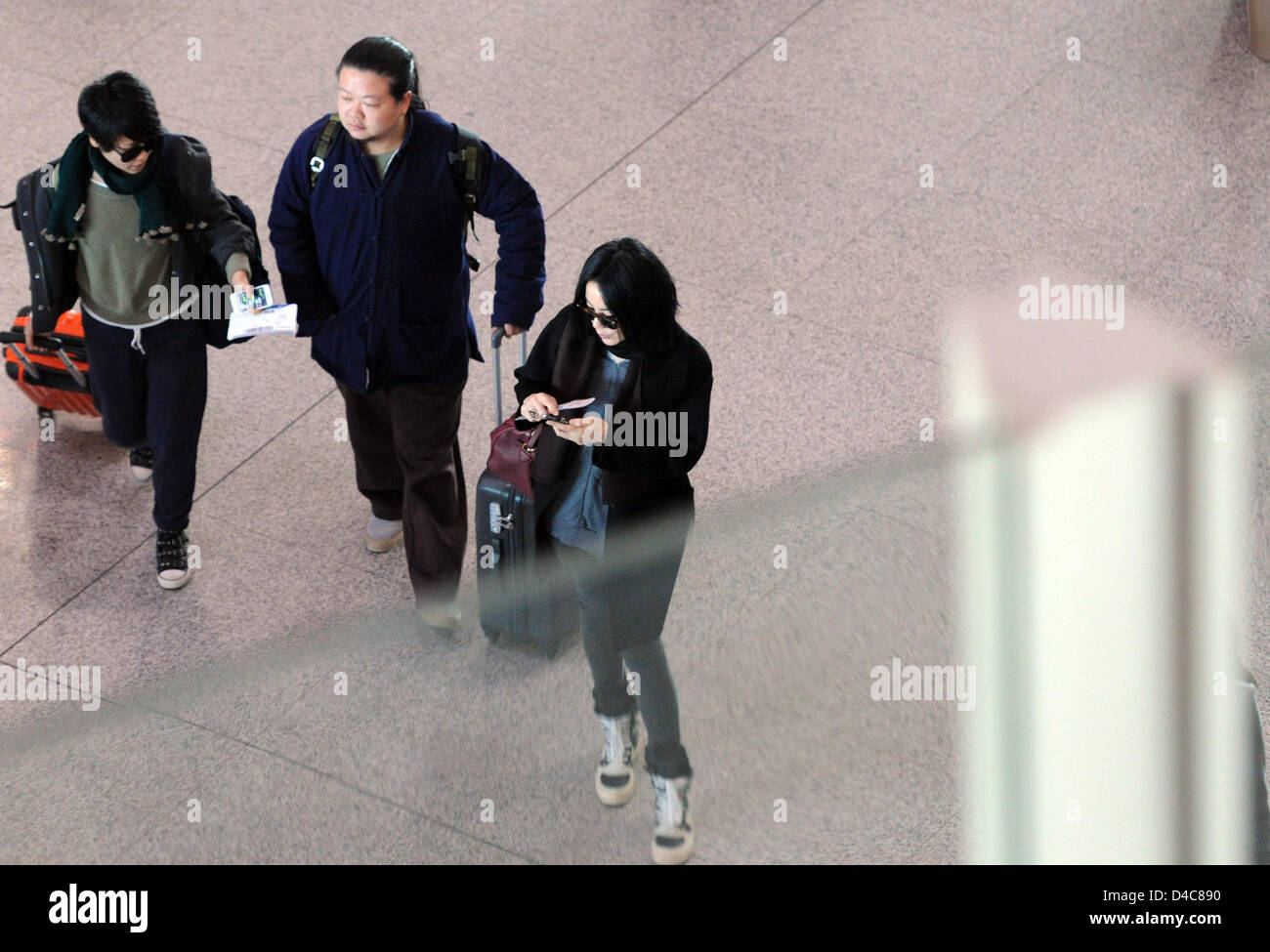 Faye Wong at the airport with her assistants in Beijing, China on Monday March 11, 2013. Stock Photo