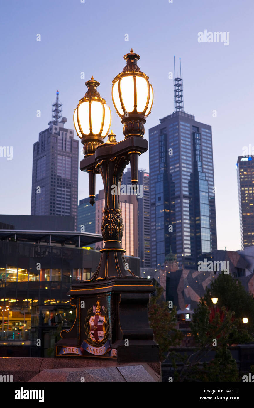 Ornate street lamp contrasts with modern architecture of city. Melbourne, Victoria, Australia Stock Photo