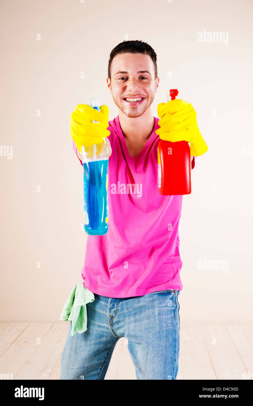 Happy young man housecleaning Stock Photo