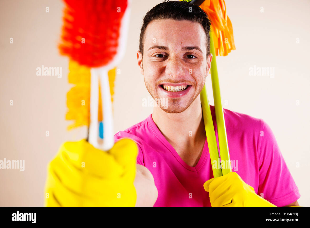 Happy young man housecleaning, portrait Stock Photo