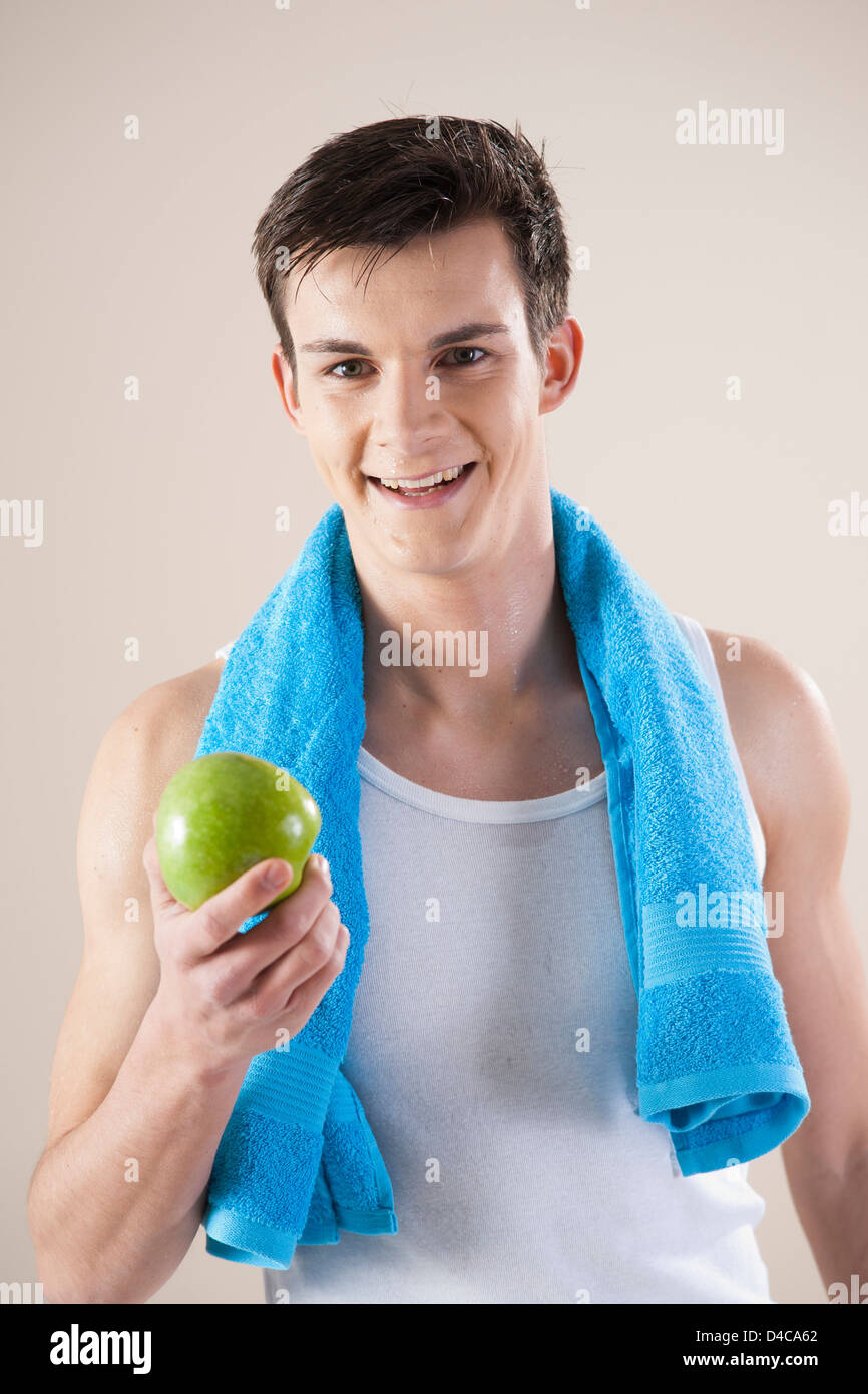 young smiling man with an apple Stock Photo