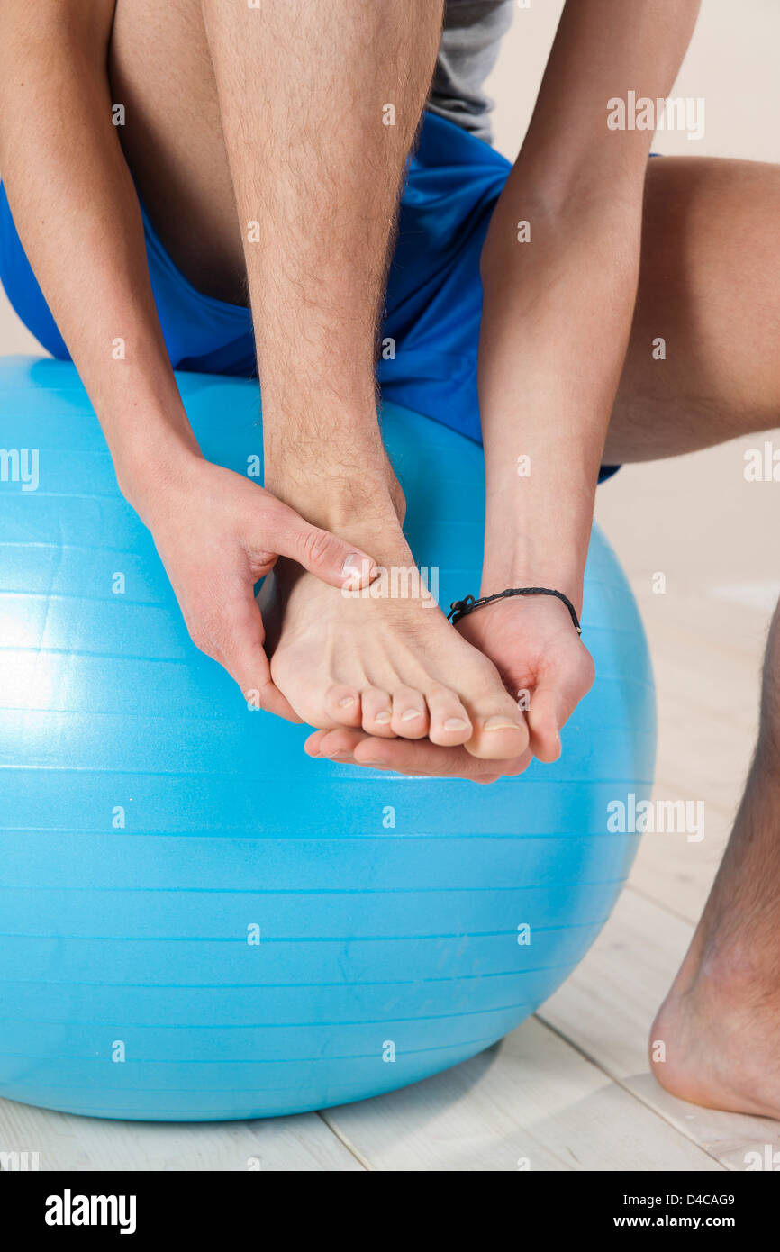 young man touching his injured foot Stock Photo