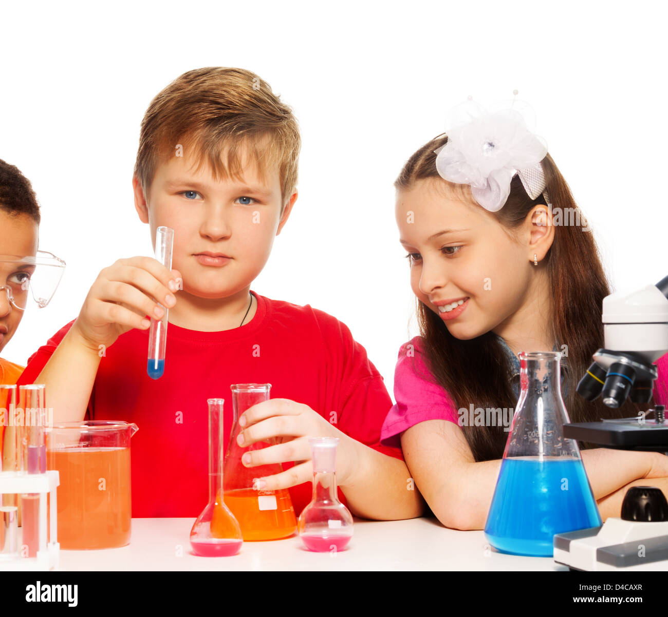 Boy and girl experimenting with chemistry mixing liquids Stock Photo