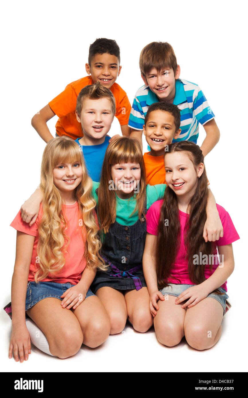 Group of 7 happy smiling kids together in a team Stock Photo