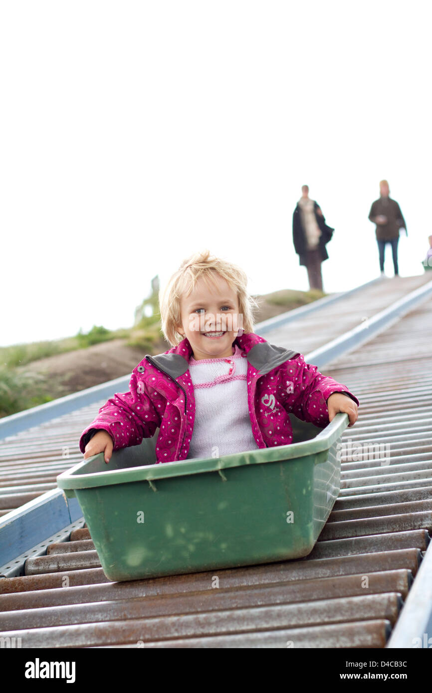 Toddler with box on slide Stock Photo