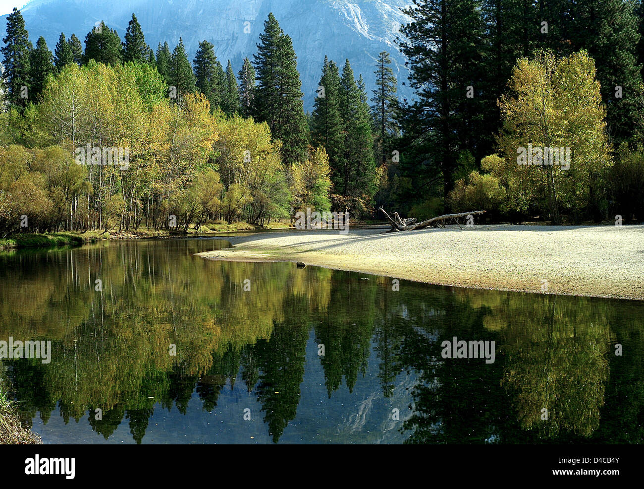 A reflection of the Half Dome seen in a lake at Yosemite National Park ...