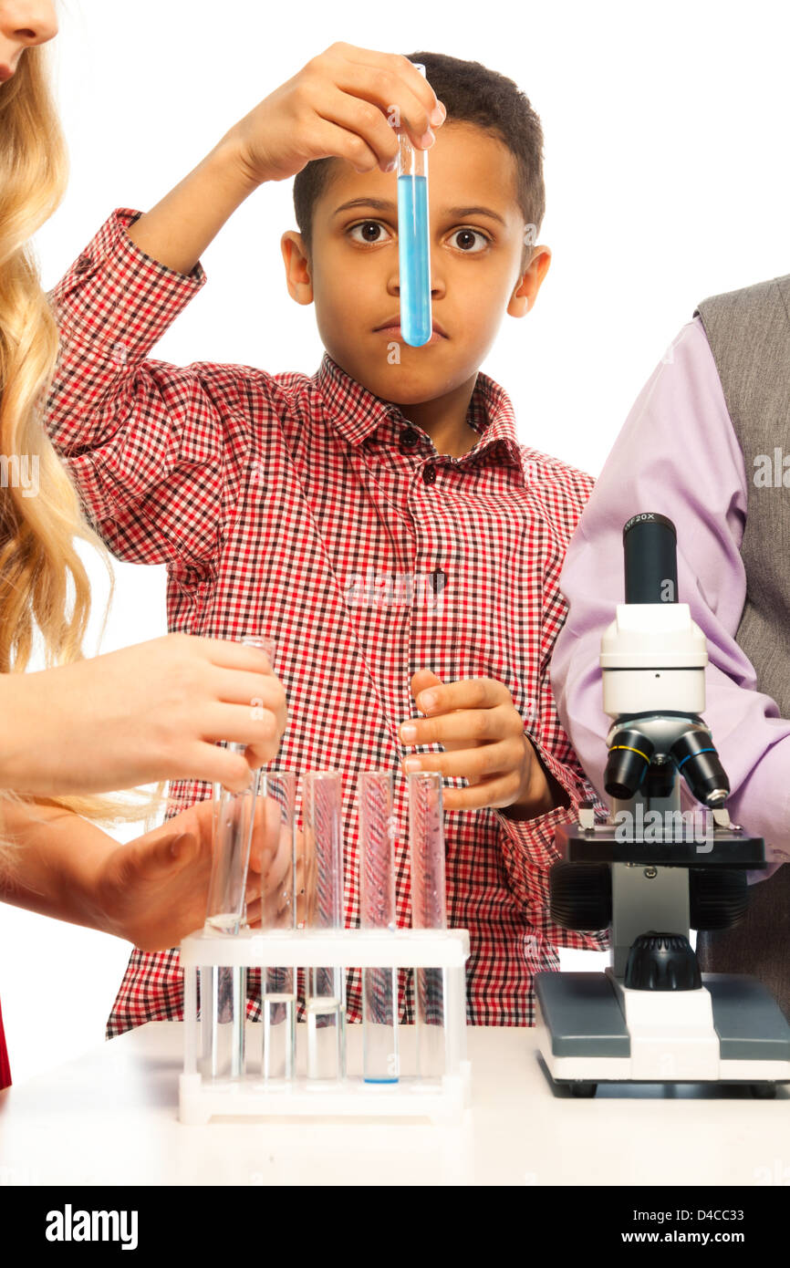 Smart black boy examining test tube on chemistry class Stock Photo