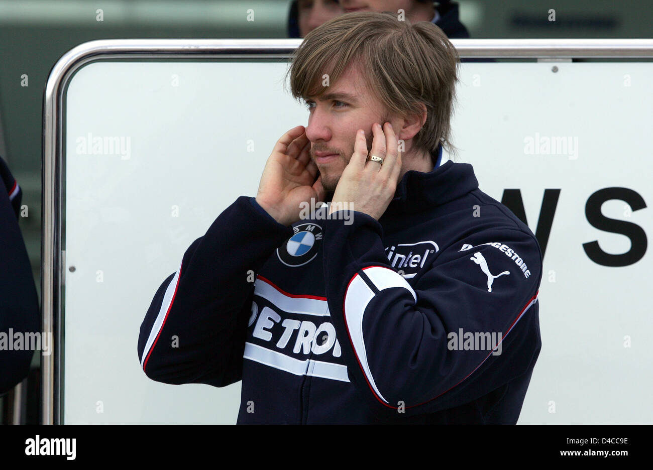 German Formula One driver Nick Heidfeld of BMW Sauber protects his ears as the new 'F1.08' is out for a test drive on the circuit of Valencia, Spain, 15 January 2008. The new F1 car was presented the previous day in Munich, Germany. Photo: GERO BRELOER Stock Photo