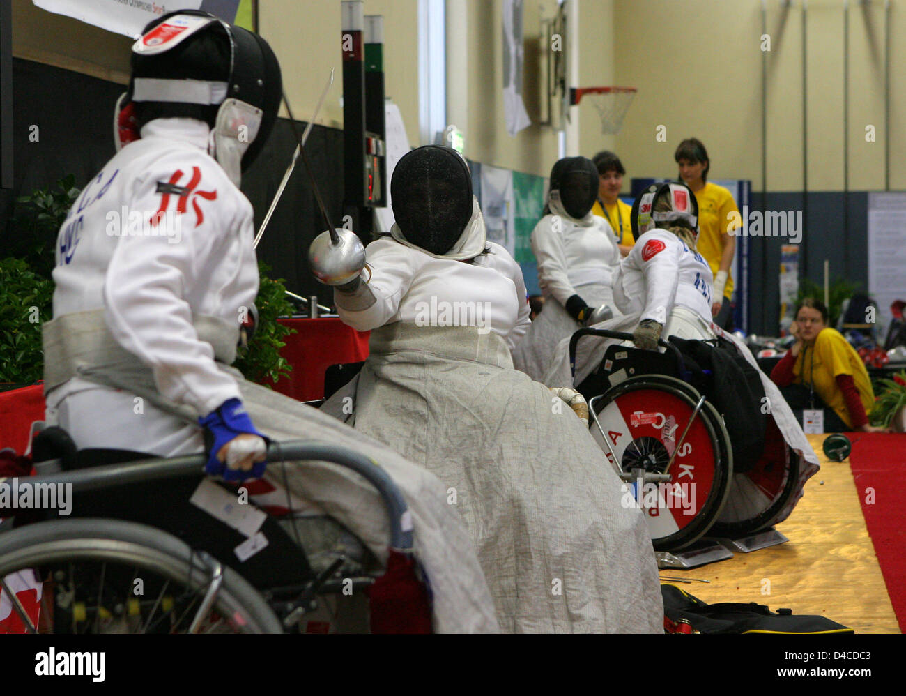 Wheel chair fencers shown in action during a preliminary round fight at the Wheel Chair World Cup in Malchow, Germany, 18 January 2008. Until Sunday 20 January 2008 113 athletes from 21 countries compete at  the World Cup event, which resembles a final chance to qualify for the Paralympics in Beijing. Photo: BERND WUESTNECK Stock Photo