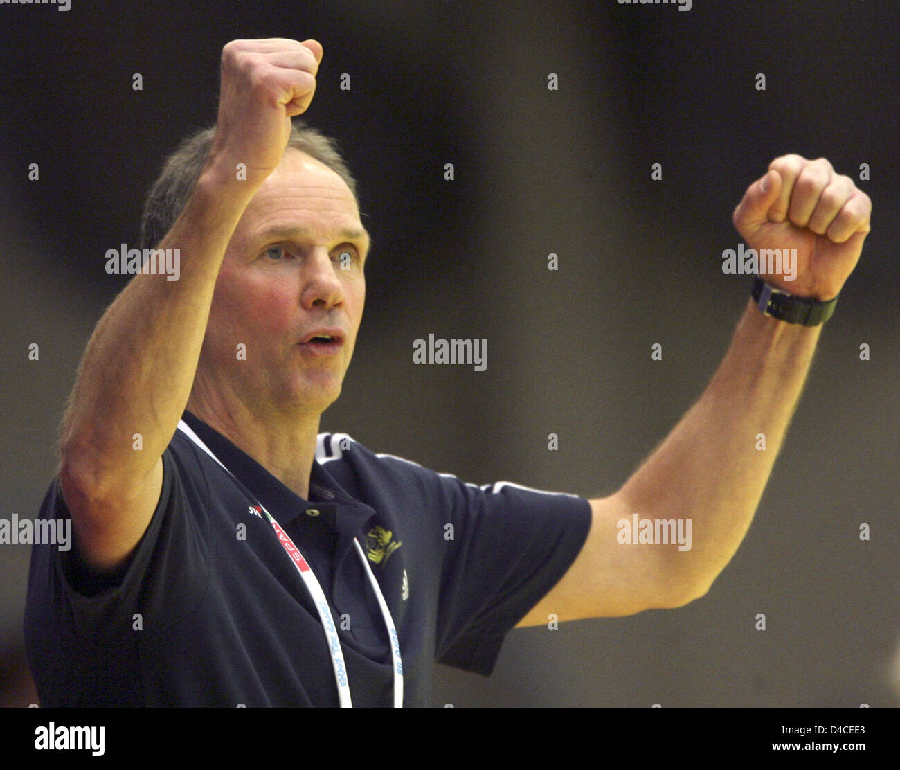 Sweden's national handball coach Ingemar Linnell cheers at the side