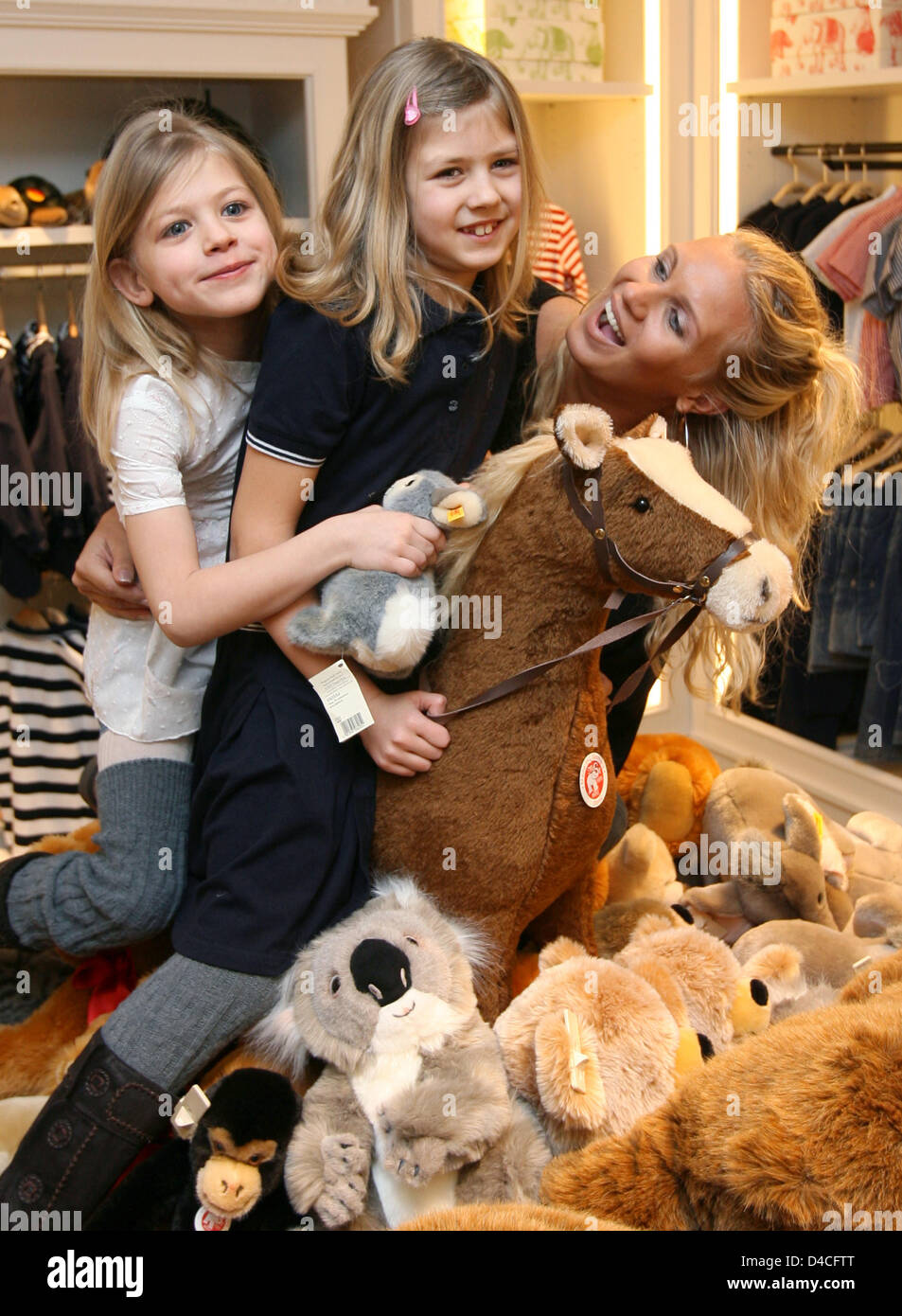 German former gymnast Magdalena Brzeska (R) poses with her daughters Caprice  (C) and Noemi (L) at a new-opened Steiff store in Stuttgart, Germany, 29  January 2008. Brzeska has won numerous titles in