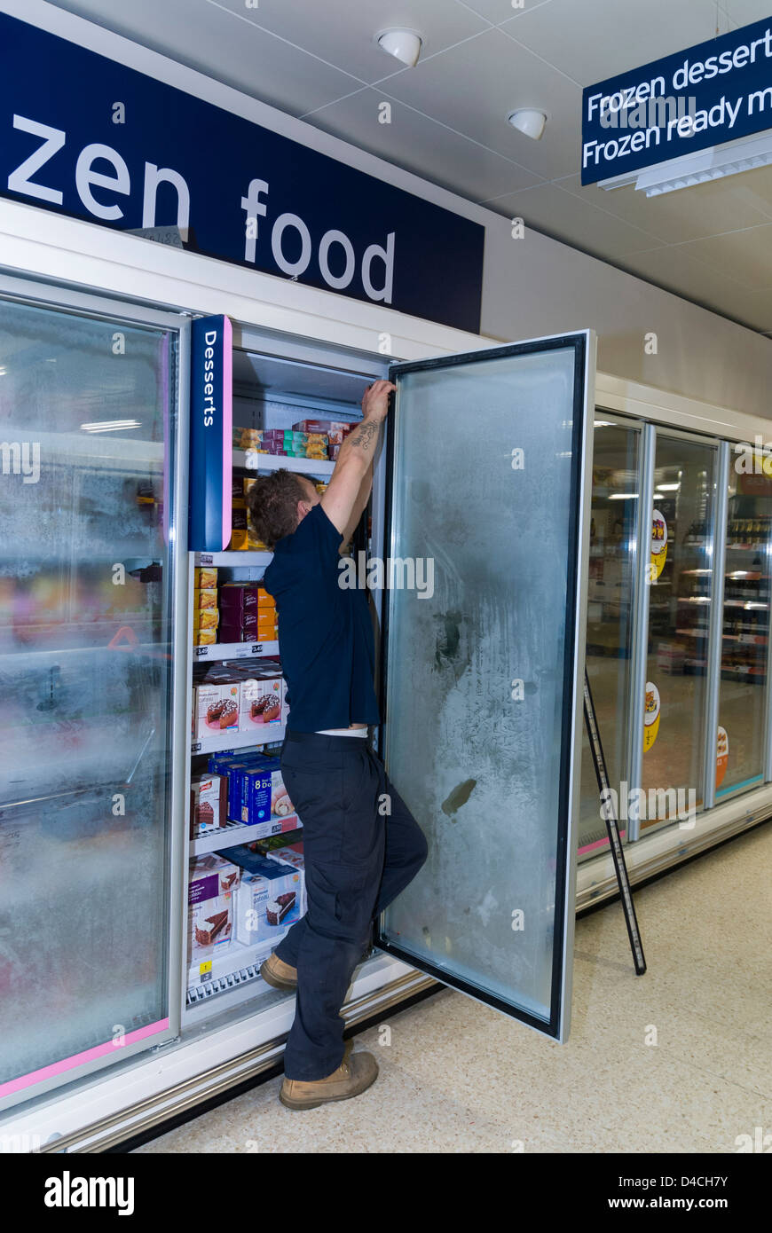 Engineer working on supermarket freezer cabinet Stock Photo