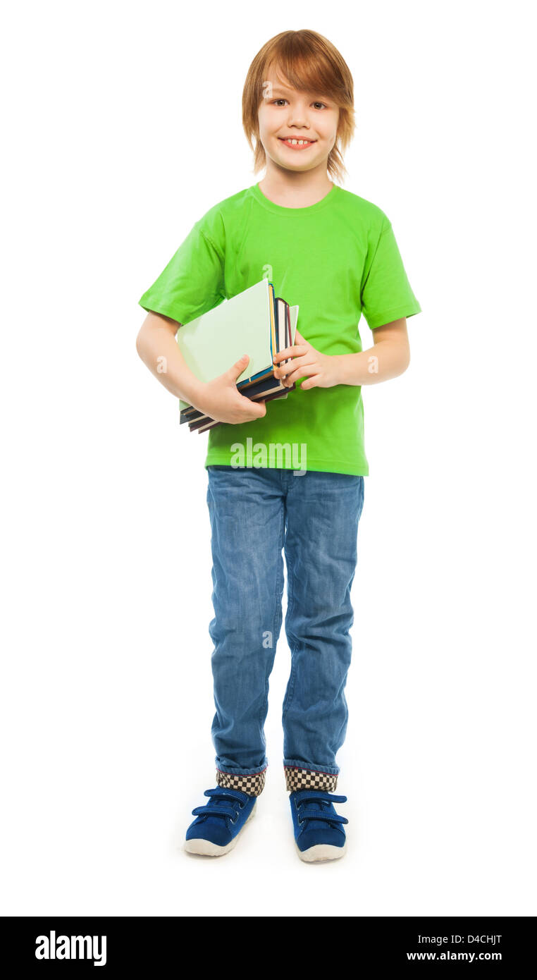 Happy Caucasian 9 years old boy in green shirt holding pile of books, full height portrait, isolated on white Stock Photo