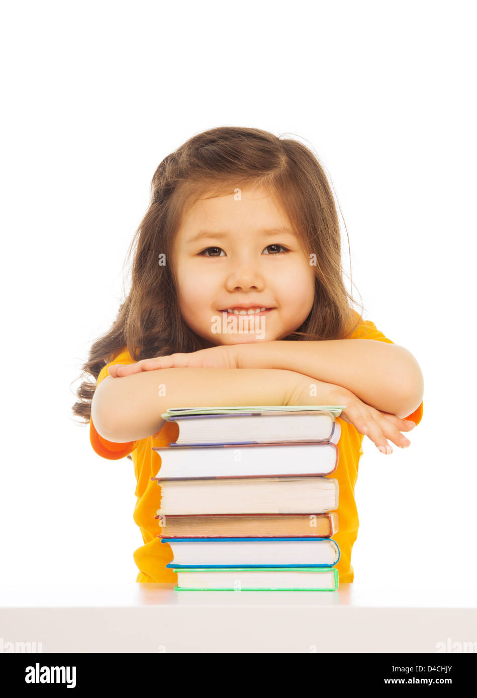 Beautiful Asian girl with long hairs laying on pile of books on the table, smiling, laughing, isolated on white Stock Photo