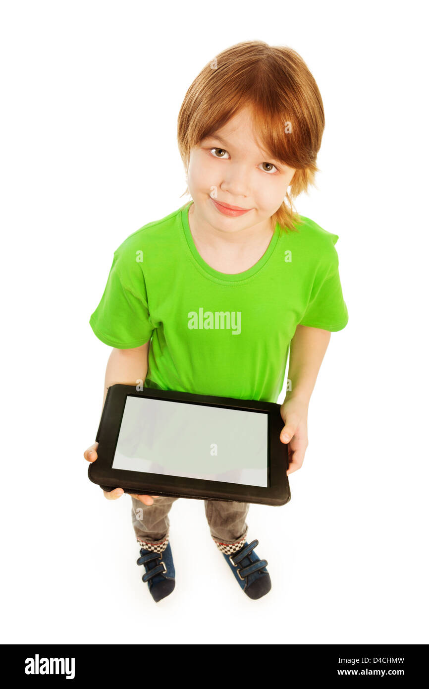 Happy Caucasian 9 years old boy in green shirt top view, holding digital tablet, isolated on white Stock Photo
