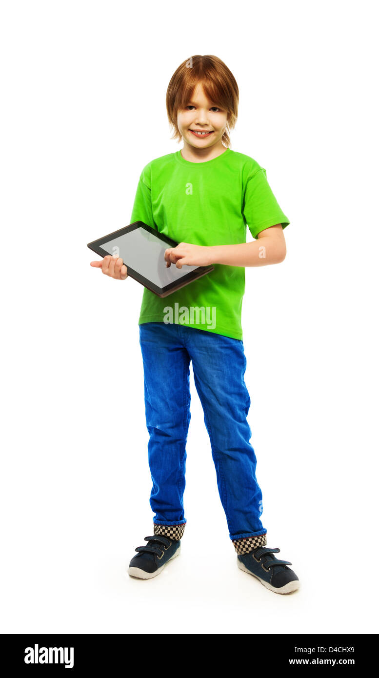 Happy Caucasian 9 years old boy in green shirt with digital tablet computer, full height portrait, isolated on white Stock Photo