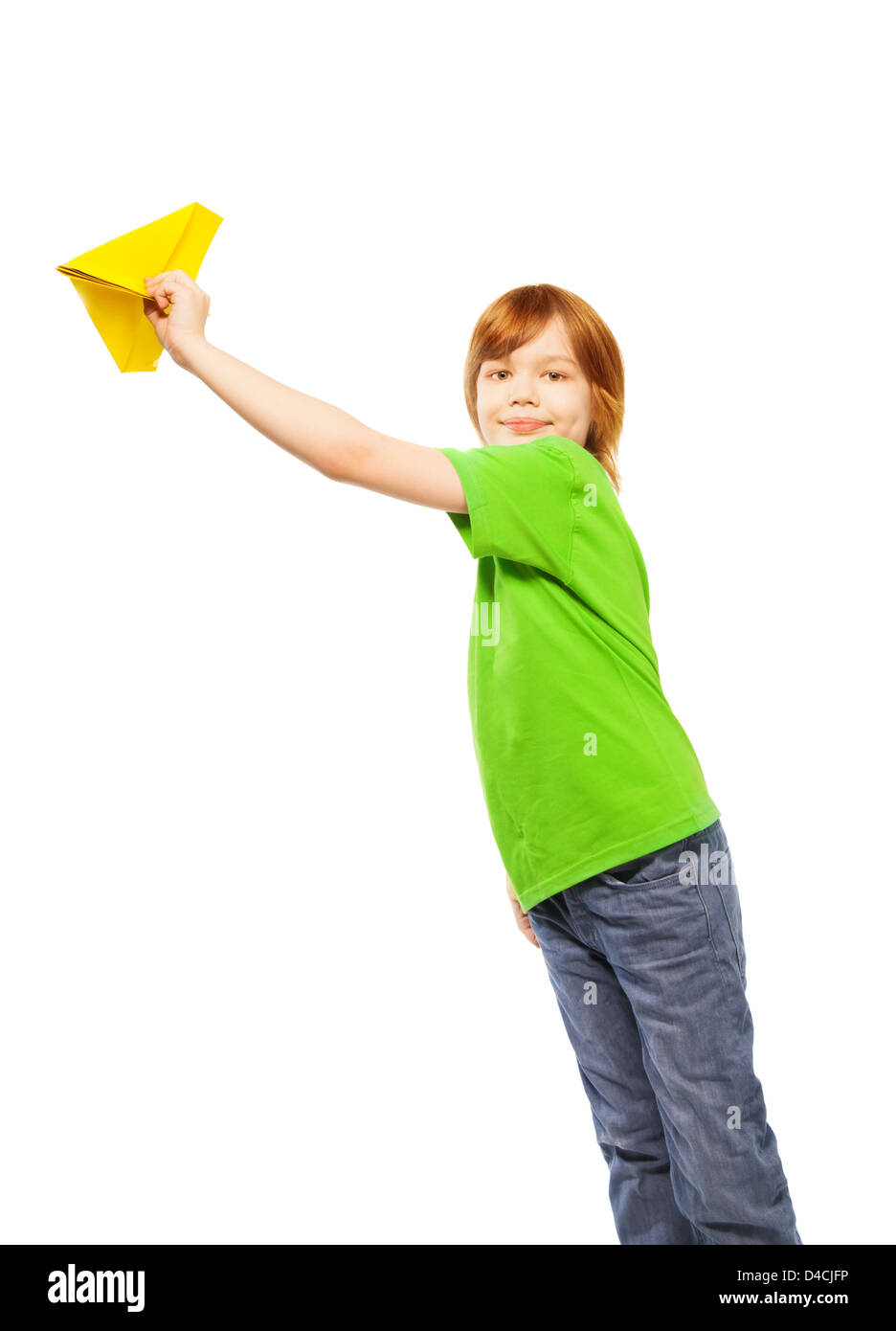 Happy Caucasian 9 years old boy in green shirt holding yellow paper plane, isolated on white Stock Photo