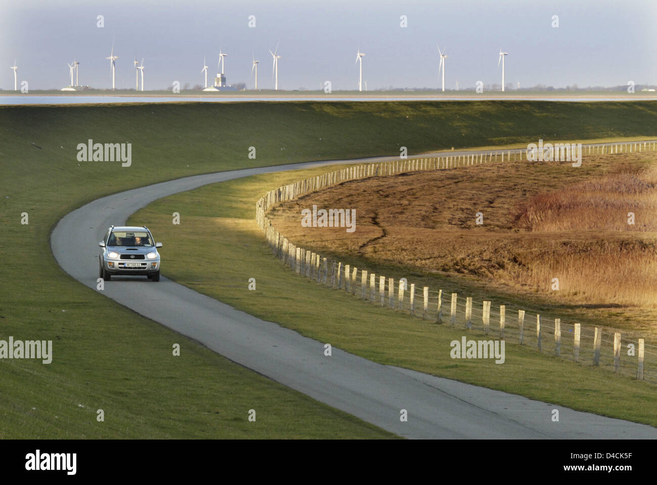 A car passes around the Beltringharder Polder, Germany, 27 November 2007. The 'Beltringharder Polder', built in 1987 as one of the most disputed dyke construction in German history, celebrates its 20th anniversary. Today, more than 10,000 pairs of birds nest and hatch there, among them 94 species of the Red List. Photo: Christian Hager Stock Photo