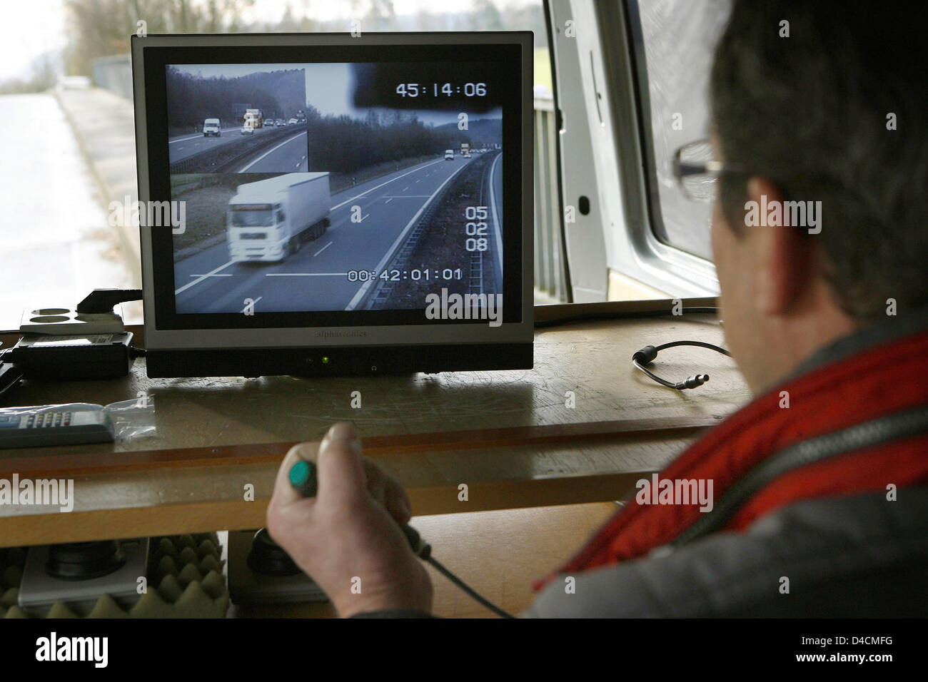 A member of the traffic control police measures the distance between ...