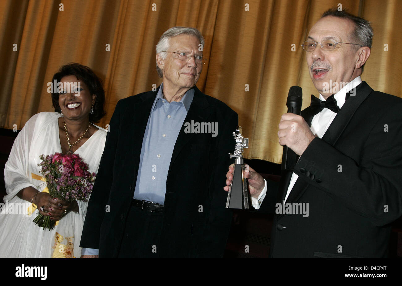Festival director Dieter Kosslick (R) presents the Berlinale Camera to Austrian actor Karlheinz Boehm (C) who is accompanied by his wife Almaz at the 58th Berlin International Film Festival in Berlin, Germany, 13 February 2008. The Berlinale Camera is presented to film personalities or institutions to which the Berlinale feels indebted or wishes to express thanks since 1986. Photo: Stock Photo