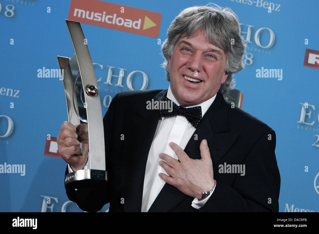 German children's songwriter Rolf Zuckowski smiles with his ECHO