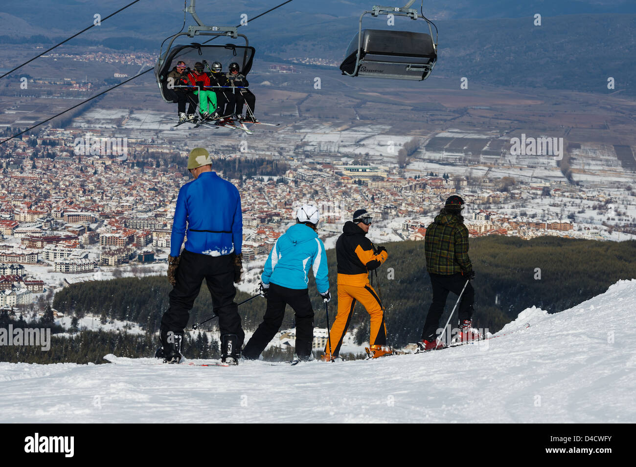 Mountain skiers and snowboarders at top of a slope of the mountain before skiing Stock Photo