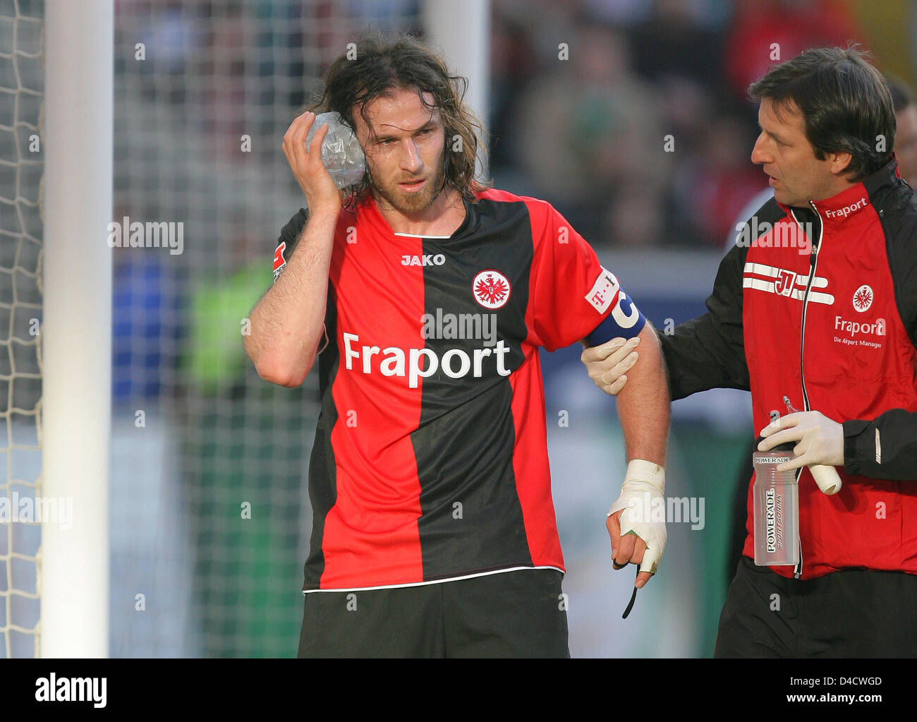 Frankfurt striker Ioannis Amanatidis (L) is treated by team doc Dr.  Christoph Seeger (R) during the Bundesliga match Eintracht Frankfurt v  Werder Bremen at Commerzbank Arena stadium of Frankfurt Main, Germany, 23