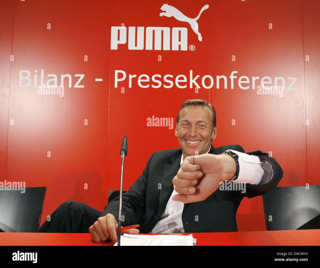 Puma CEO Jochen Zeitz checks his watch to begin the company's balance press  conference in Nuremberg, Germany, 26 February 2008. The sports goods  producer expects a growth in sales in the one-digit