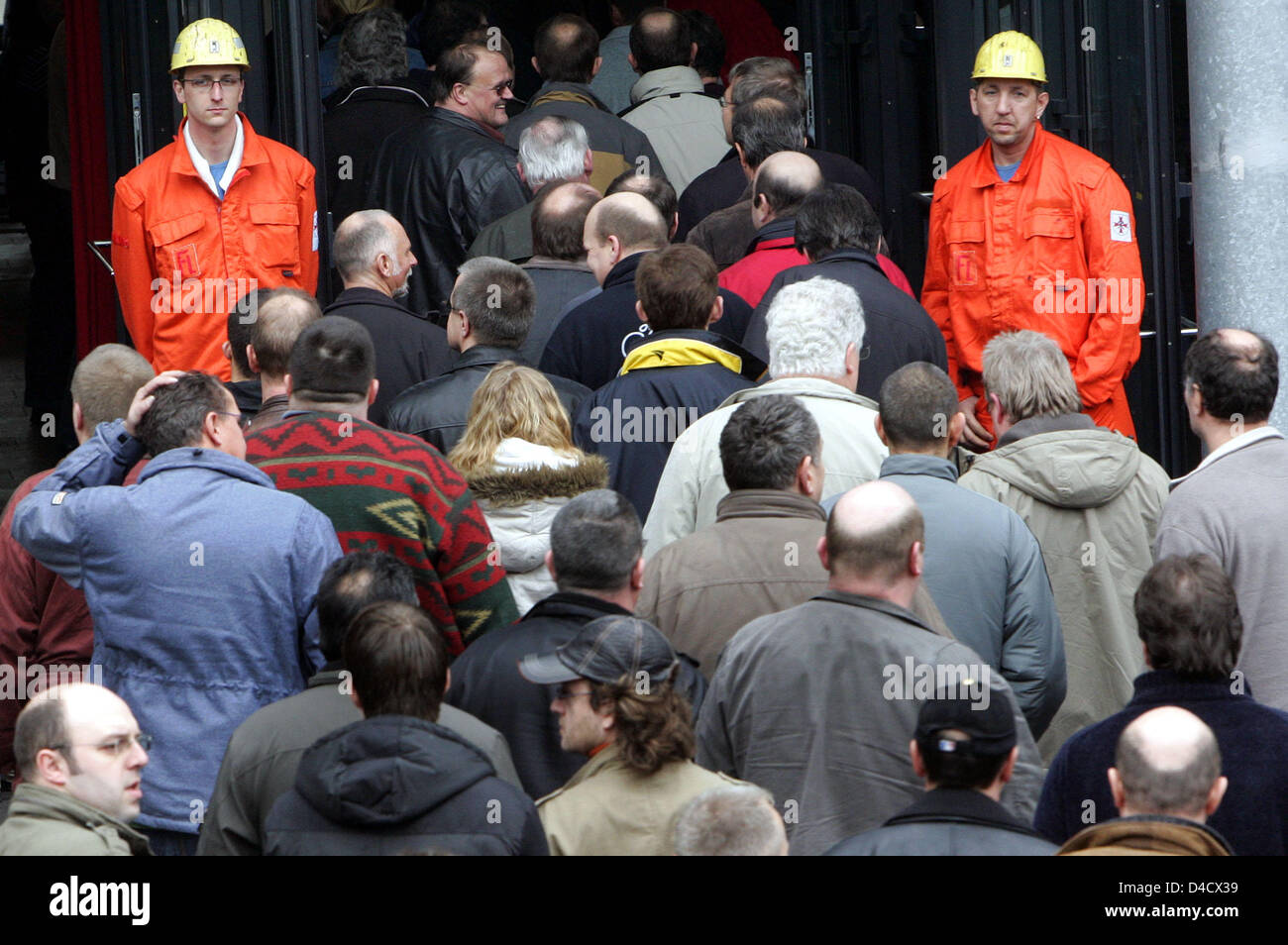 Employees and miners of 'RAG Deutsche Steinkohle' mining company arrive at the company's extraordinary works meeting in Saarbruecken, Germany, 26 February 2008. A mining related earthquake reaching 4,0 on the 'Richter' scale shook the Saar region on 23 February 2008. Since then work rests at the Saarland's only remaining mine in Ensdorf. 3600 miners are on leave and will be sent on Stock Photo
