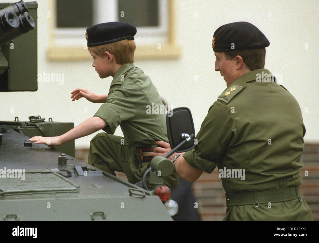 (dpa file) - Prince Harry (L) clims onto a tank turret during a visit to British troops in Bergen-Hohne, Germany, 29 July 1993. Prince Harry's long awaited Afghanistan dployment lasted only 24 hours. After his presence was reported by media all around the world, the queen's grand son was ordered back home. Photo: Wolfgang Weihs Stock Photo