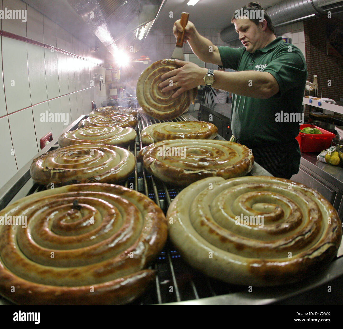 The world's biggest Thuringian sausages are fried at 'Zapfwerk I/3' restaurant in Greiz, Germany, 01 March 2008. The 1.2-kilograms specialties are offered at the restaurant that is also famous for having Europe's biggest tap beer dispensing equipment. Photo: Jan-Peter Kasper Stock Photo