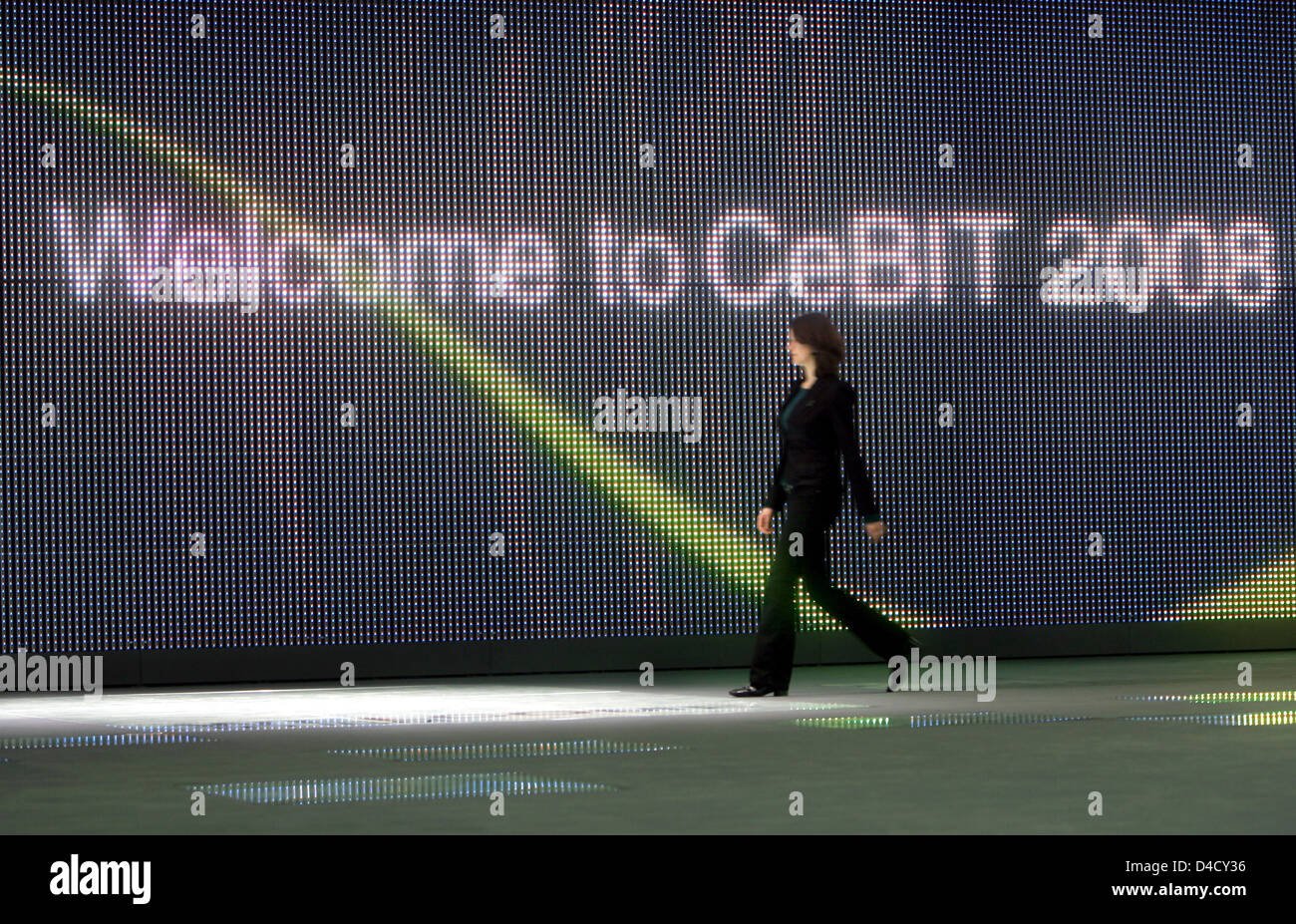 A visitors walks past a huge video screen reading ' Welcome to CeBIT 2008' at the CeBIT in Hanover, Germany, 03 March 2008. From 04 through 10 March, some 5,500 exhibitors from 75 countries showcase their latest products at the world's largest trade fair on digital IT and telecommunications solutions for home and work environments. Photo: KAY NIETFELD Stock Photo