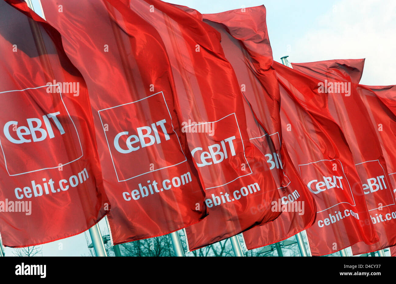 Red CeBIT flags flap in the wind at the trade fair premises in Hanover, Germany, 03 March 2008. From 04 through 10 March, some 5,500 exhibitors from 75 countries showcase their latest products at the world's largest trade fair on digital IT and telecommunications solutions for home and work environments. Photo: KAY NIETFELD Stock Photo