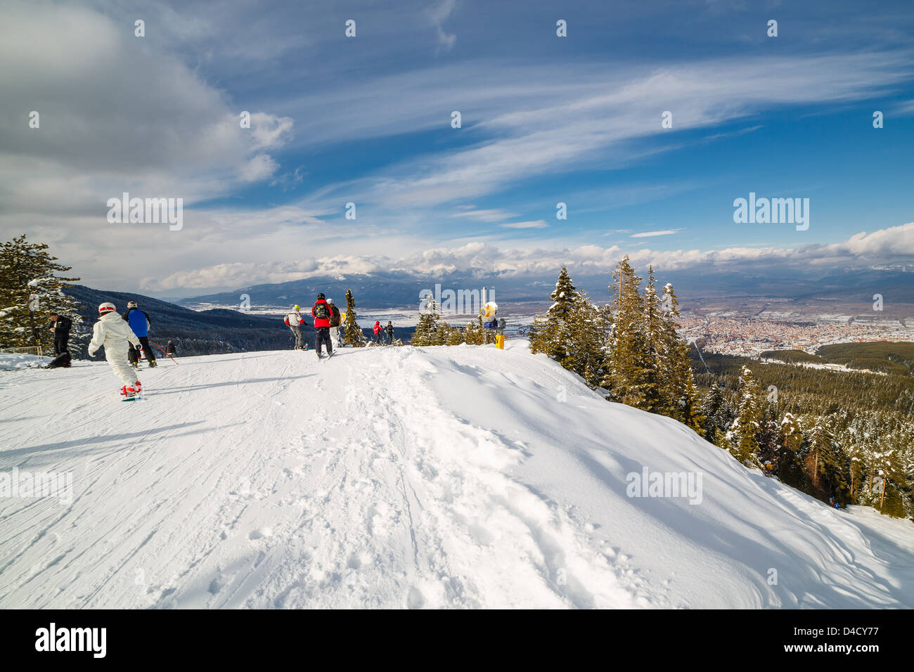 Mountain skiers and snowboarders at top of a slope of the mountain before skiing Stock Photo