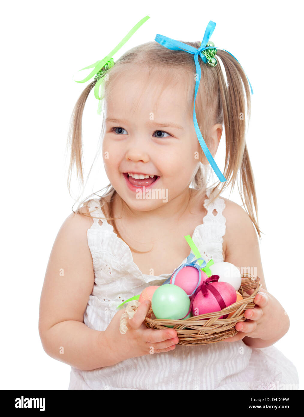 cute smiling baby girl holding Easter eggs in basket isolated on white