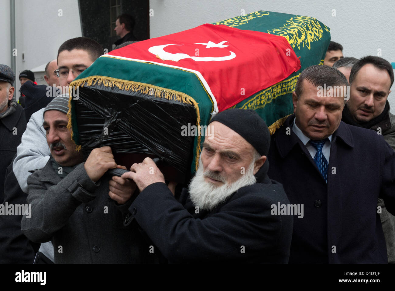 Men carry the caskets during the funeral service for the victims of the ...