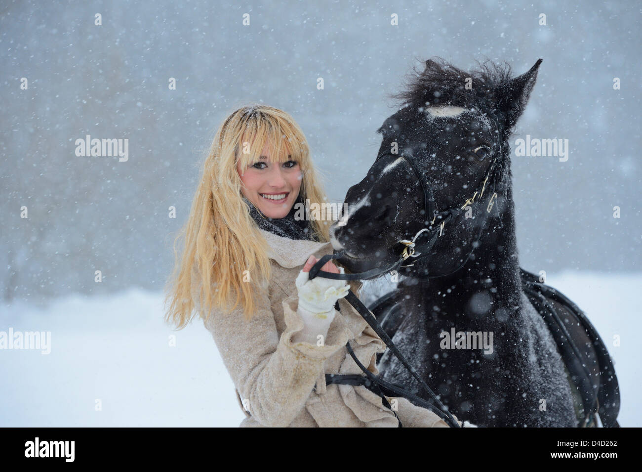 Young woman with horse in snow, Upper Palatinate, Germany, Europe Stock Photo