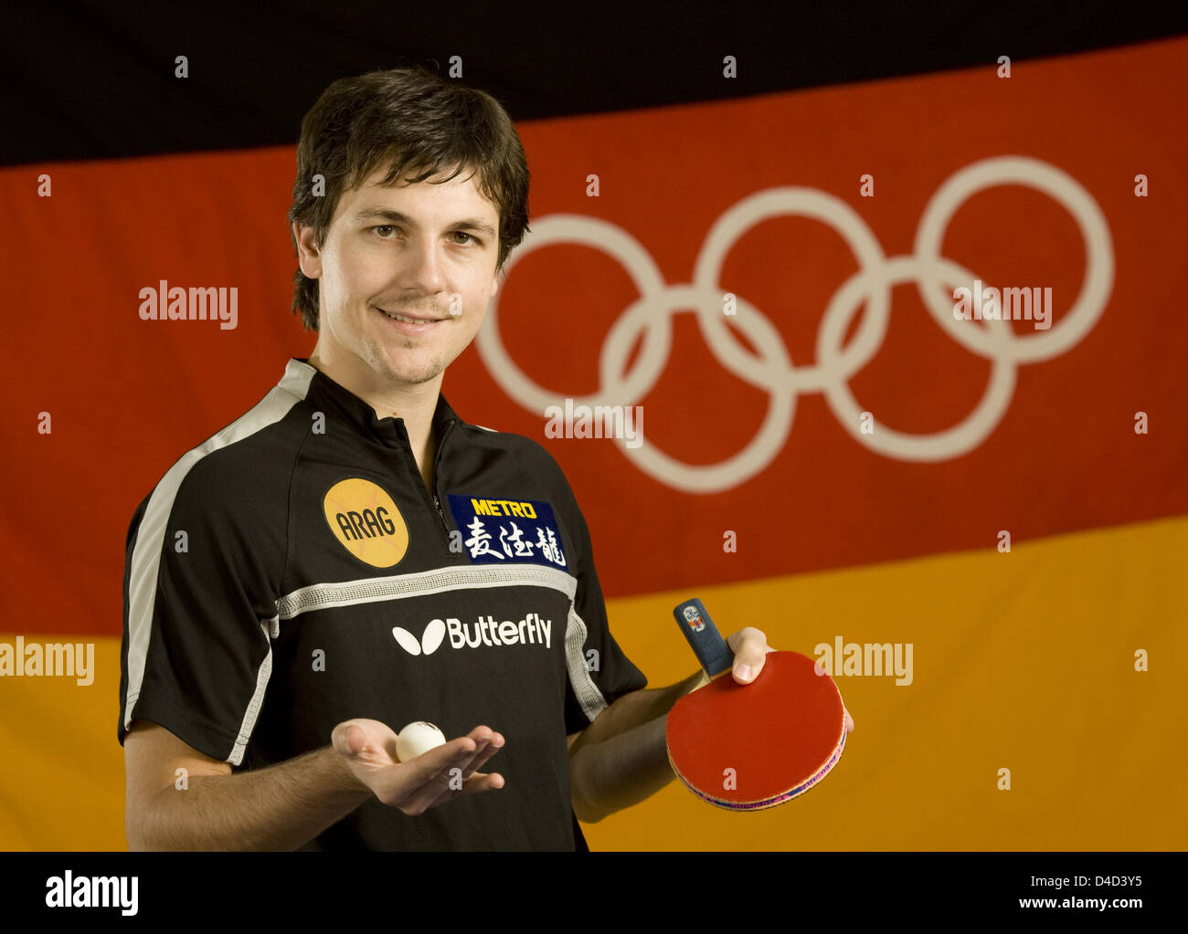 German table tennis pro Timo Boll poses in front of a German flag