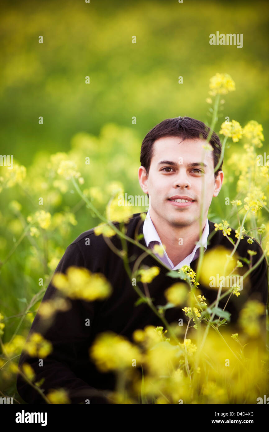 Young handsome guy on field staring at camera. Stock Photo